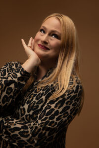 Person posing in leopard print outfit.