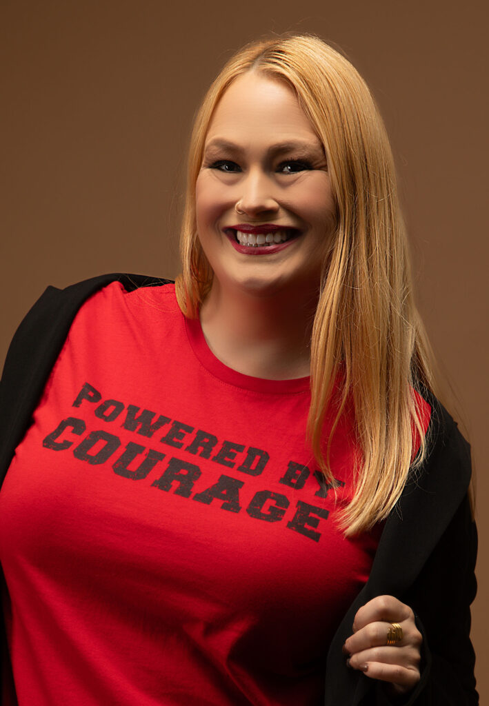 Woman in red shirt: Powered by Courage.